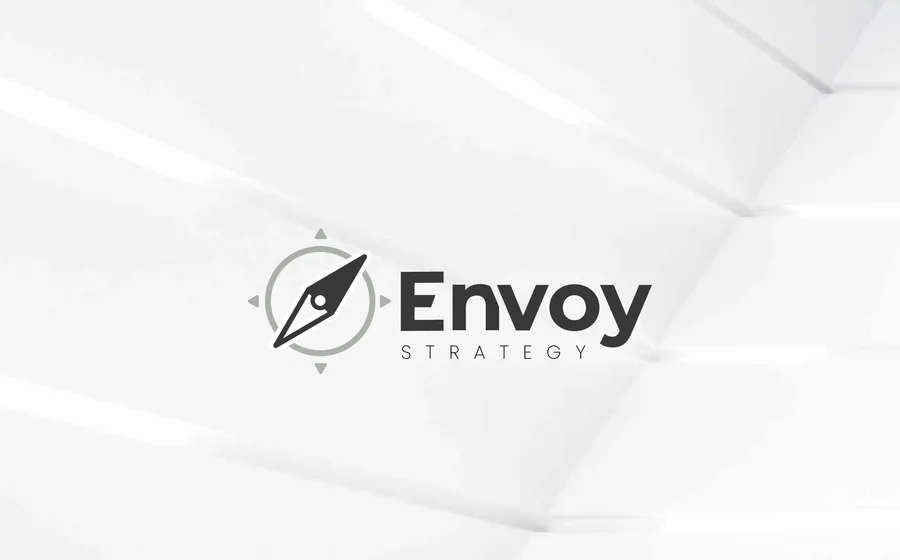 A Revision 01 logo option: a compass needle inside a grey ring, beside “Envoy” and STRATEGY.
